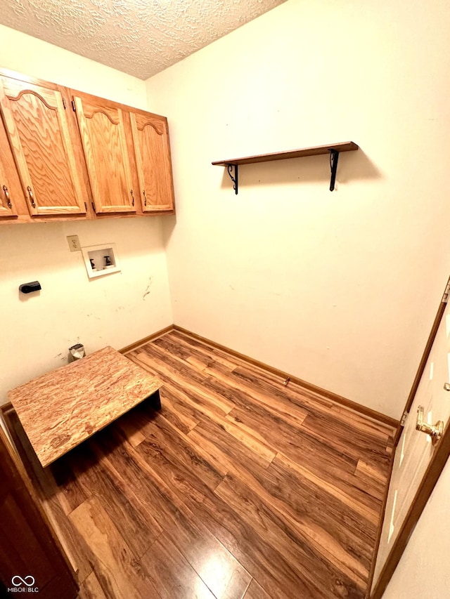526 Jefferson Vly, Coatesville, IN 46121 - washroom featuring cabinet space, hookup for a washing machine, wood finished floors, and a textured ceiling