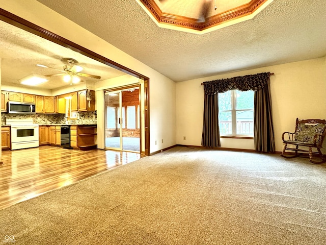 526 Jefferson Vly, Coatesville, IN 46121 - unfurnished living room featuring light colored carpet, a textured ceiling, and a ceiling fan
