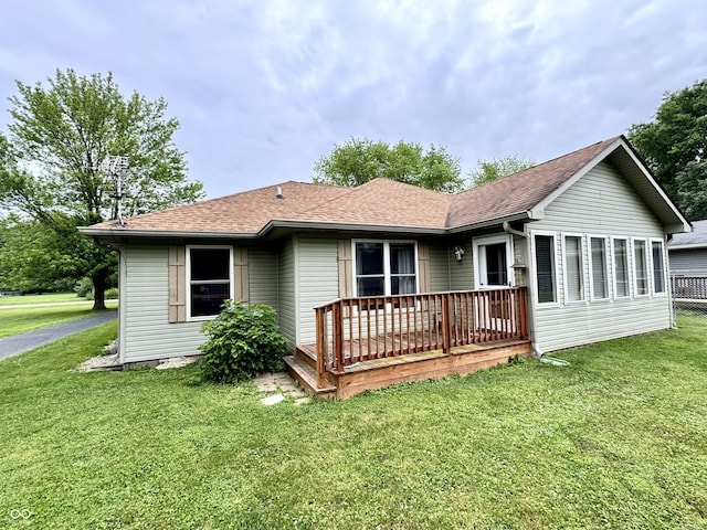 526 Jefferson Vly, Coatesville, IN 46121 - back of property featuring a lawn, a shingled roof, and a deck