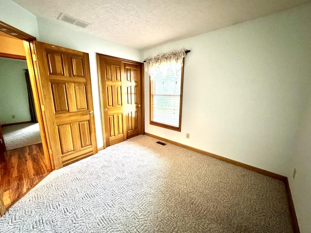 526 Jefferson Vly, Coatesville, IN 46121 - unfurnished bedroom with carpet flooring, a textured ceiling, and a closet
