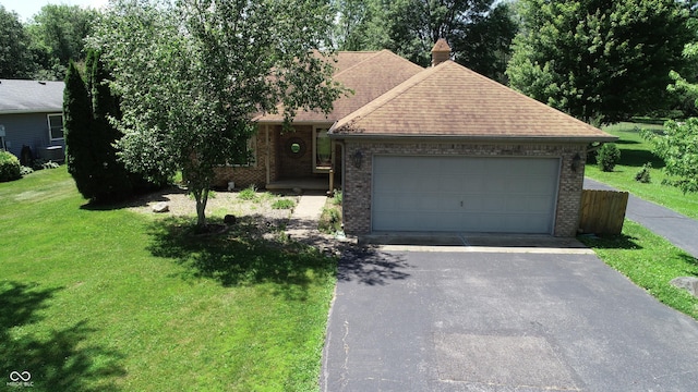 526 Jefferson Vly, Coatesville, IN 46121 - view of front of house with brick siding, a front lawn, driveway, roof with shingles, and an attached garage