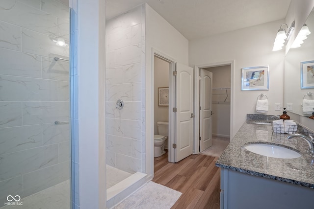 9728 Junction, Fishers, IN 46037 - bathroom featuring a shower stall, double vanity, wood finished floors, and a walk in closet