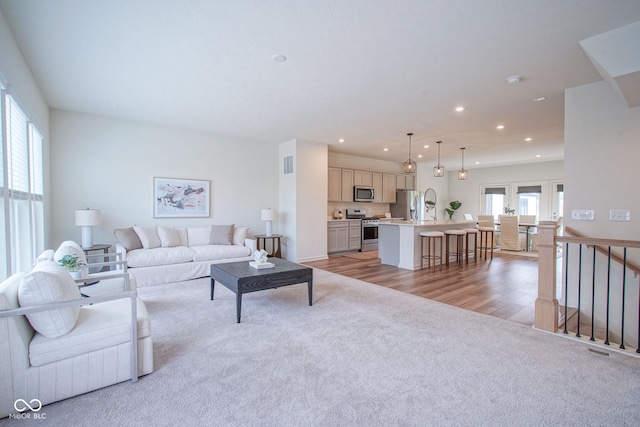 9728 Junction, Fishers, IN 46037 - living area featuring light colored carpet, recessed lighting, and light wood-type flooring