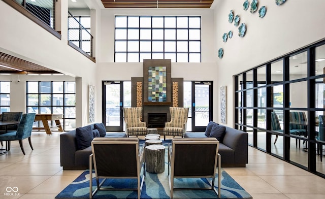9728 Junction, Fishers, IN 46037 - tiled living room featuring plenty of natural light, a fireplace, and a towering ceiling