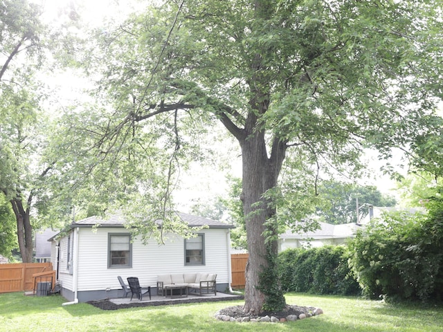 4445 Kingsley Dr, Indianapolis, IN 46205 - rear view of house with an outdoor living space, a fenced backyard, and a patio