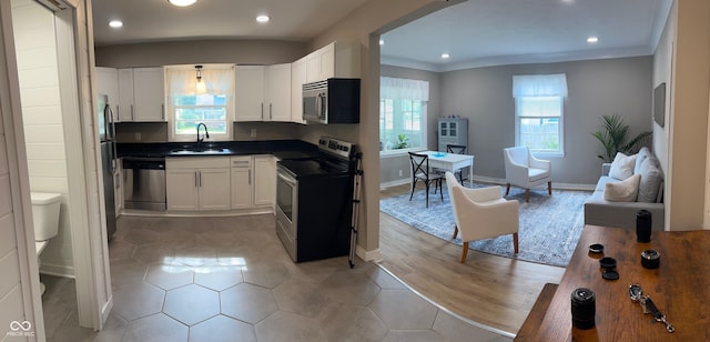 4445 Kingsley Dr, Indianapolis, IN 46205 - kitchen featuring stainless steel appliances, white cabinets, dark countertops, recessed lighting, and crown molding