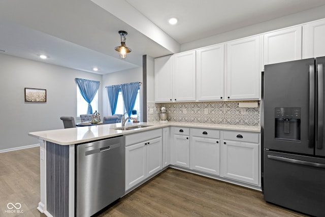 2733 Lamar Dr, Whitestown, IN 46075 - kitchen featuring stainless steel appliances, light countertops, dark wood-style flooring, decorative backsplash, and recessed lighting