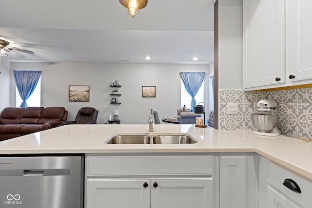 2733 Lamar Dr, Whitestown, IN 46075 - kitchen featuring stainless steel dishwasher, open floor plan, white cabinets, a ceiling fan, and backsplash