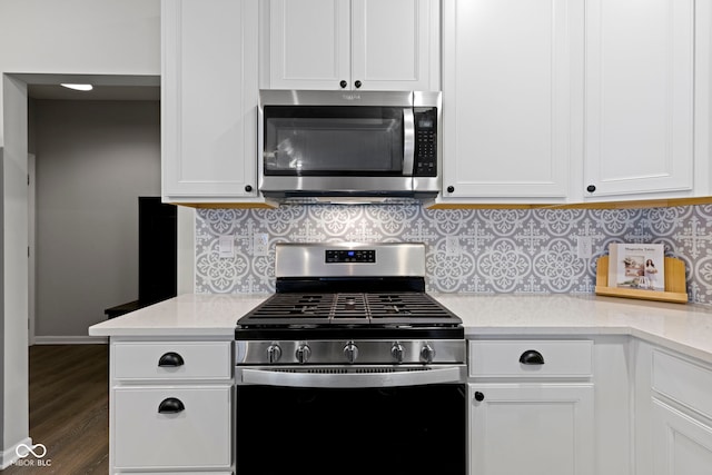 2733 Lamar Dr, Whitestown, IN 46075 - kitchen with stainless steel appliances, white cabinets, dark wood finished floors, and tasteful backsplash
