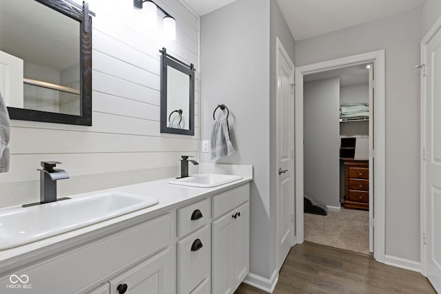 2733 Lamar Dr, Whitestown, IN 46075 - full bath featuring wood finished floors, double vanity, a walk in closet, and a shower