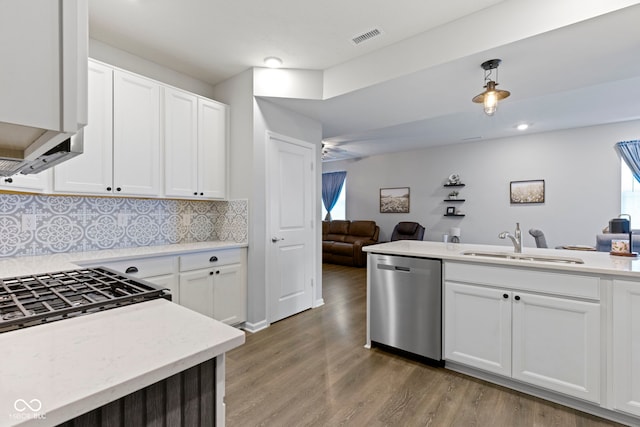 2733 Lamar Dr, Whitestown, IN 46075 - kitchen with dishwasher, open floor plan, decorative backsplash, light wood-type flooring, and white cabinetry