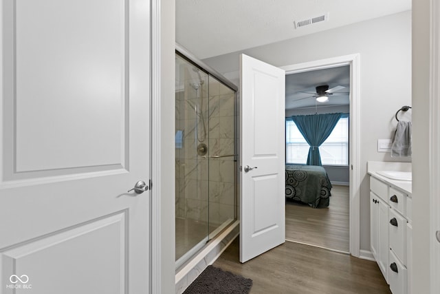 2733 Lamar Dr, Whitestown, IN 46075 - ensuite bathroom with a shower stall, wood finished floors, vanity, and a ceiling fan