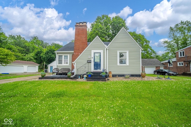 4210 Main St, Anderson, IN 46013 - rear view of property featuring a chimney, entry steps, a yard, and a detached garage