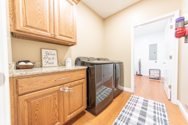 8090 N State Highway 7, Elizabethtown, IN 47232 - washroom featuring cabinet space, washing machine and dryer, light wood-style flooring, and electric panel