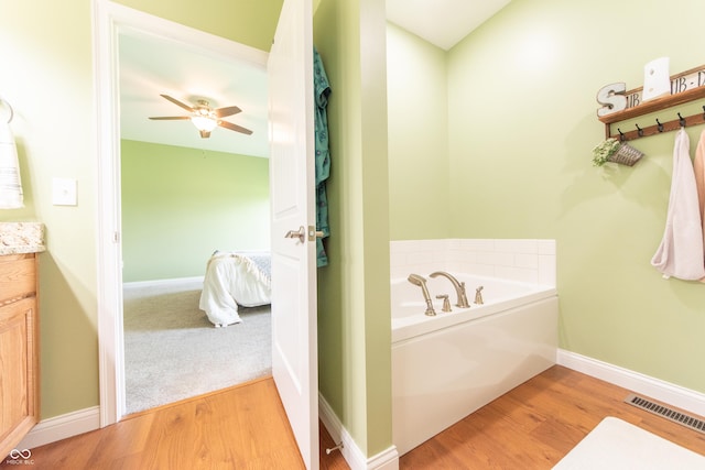 8090 N State Highway 7, Elizabethtown, IN 47232 - bathroom featuring vanity, a bath, wood finished floors, and a ceiling fan