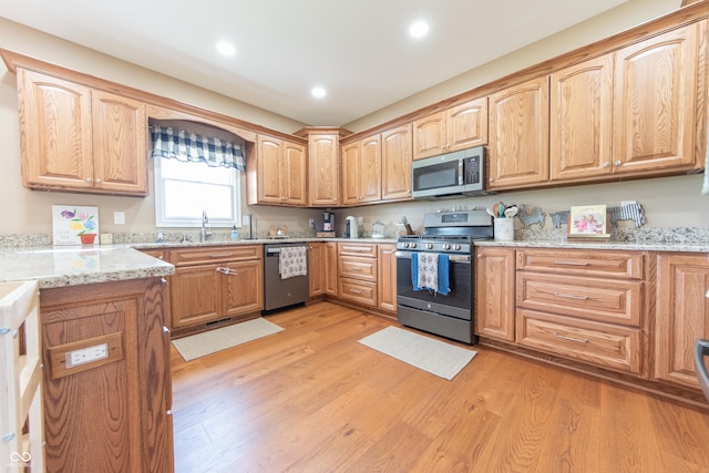 8090 N State Highway 7, Elizabethtown, IN 47232 - kitchen with appliances with stainless steel finishes, light stone countertops, recessed lighting, and light wood-type flooring