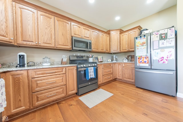8090 N State Highway 7, Elizabethtown, IN 47232 - kitchen featuring appliances with stainless steel finishes, light wood-style floors, light stone countertops, and recessed lighting