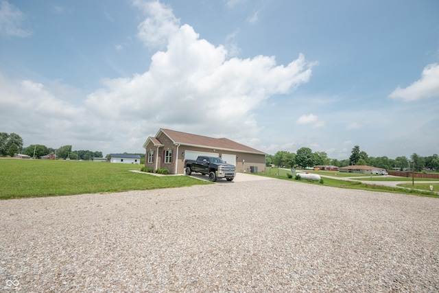 8090 N State Highway 7, Elizabethtown, IN 47232 - view of side of home featuring gravel driveway, a lawn, and an attached garage