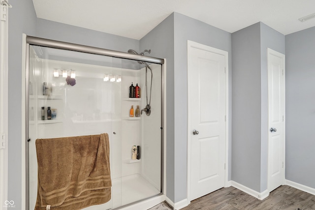 5812 Flat Hill Dr, Indianapolis, IN 46239 - bathroom with wood finished floors and a stall shower