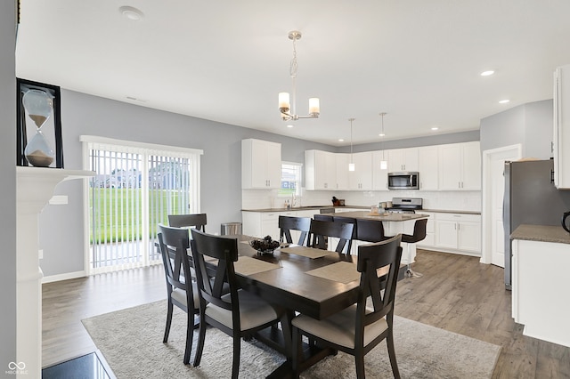 5812 Flat Hill Dr, Indianapolis, IN 46239 - dining space featuring a chandelier, wood finished floors, and recessed lighting