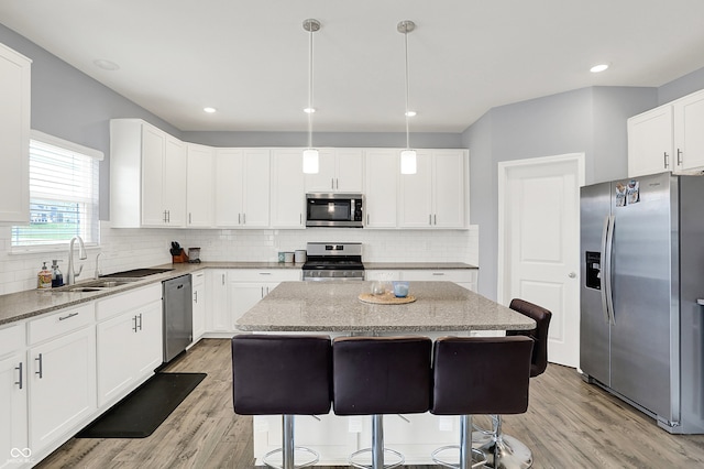 5812 Flat Hill Dr, Indianapolis, IN 46239 - kitchen with appliances with stainless steel finishes, light stone countertops, light wood finished floors, backsplash, and recessed lighting