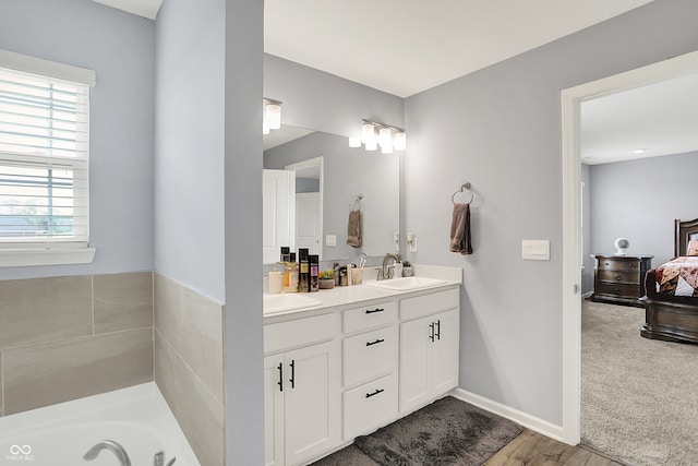 5812 Flat Hill Dr, Indianapolis, IN 46239 - ensuite bathroom featuring double vanity, wood finished floors, and a tub