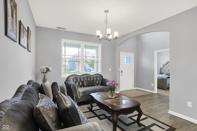 5812 Flat Hill Dr, Indianapolis, IN 46239 - living room with arched walkways, a chandelier, and wood finished floors