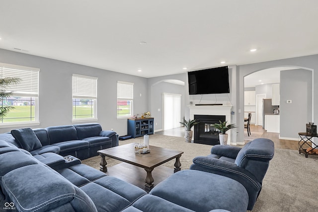 5812 Flat Hill Dr, Indianapolis, IN 46239 - living area with arched walkways, recessed lighting, a fireplace, and light wood finished floors