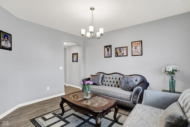 5812 Flat Hill Dr, Indianapolis, IN 46239 - living room featuring arched walkways, a chandelier, and wood finished floors
