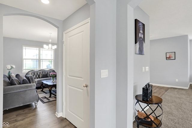 5812 Flat Hill Dr, Indianapolis, IN 46239 - corridor with arched walkways, a chandelier, and wood finished floors
