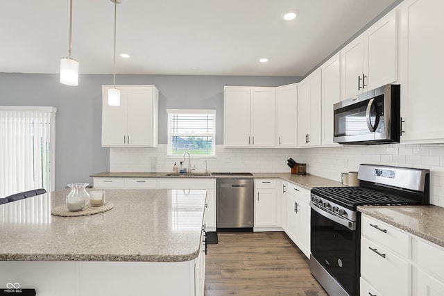 5812 Flat Hill Dr, Indianapolis, IN 46239 - kitchen featuring appliances with stainless steel finishes, light stone countertops, decorative backsplash, white cabinets, and recessed lighting