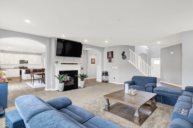 5812 Flat Hill Dr, Indianapolis, IN 46239 - living area with recessed lighting, arched walkways, stairs, and light wood-style floors