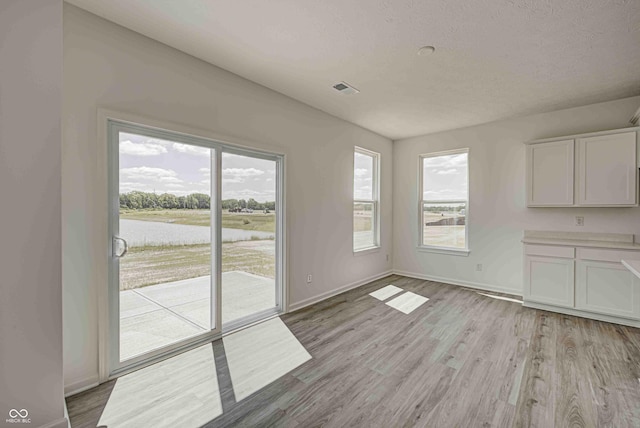 7501 Firecrest Ln, Camby, IN 46113 - unfurnished dining area with a water view and light wood finished floors