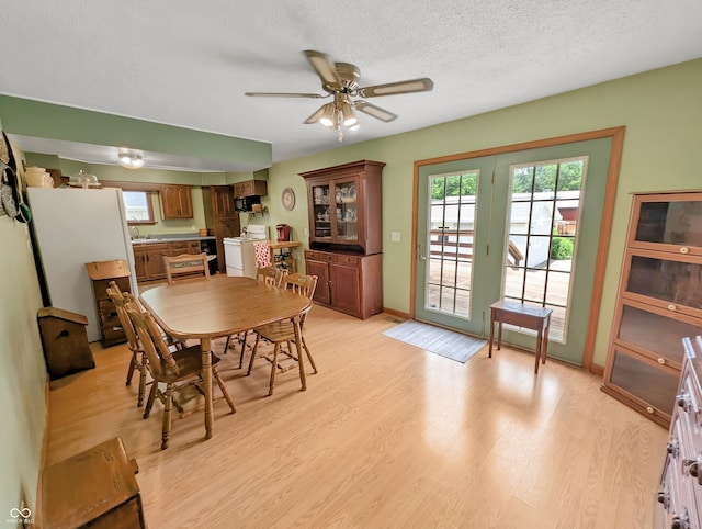 308 W Jefferson St, Kirklin, IN 46050 - dining room featuring light wood-style floors, ceiling fan, healthy amount of natural light, and a textured ceiling