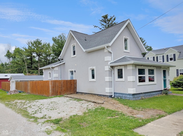 308 W Jefferson St, Kirklin, IN 46050 - view of side of property featuring stucco siding and a shingled roof