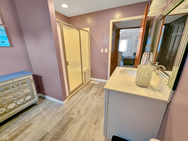 308 W Jefferson St, Kirklin, IN 46050 - bathroom with vanity, wood finished floors, a stall shower, and recessed lighting