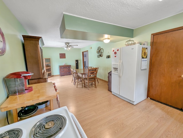 308 W Jefferson St, Kirklin, IN 46050 - kitchen with white fridge with ice dispenser, light wood-style floors, a ceiling fan, and a textured ceiling
