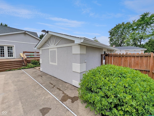308 W Jefferson St, Kirklin, IN 46050 - view of side of property featuring stucco siding, a wooden deck, and a patio