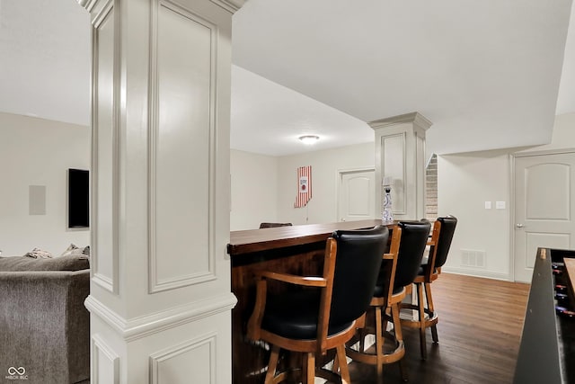 15410 Mission Hills Dr, Carmel, IN 46033 - indoor dry bar featuring dark wood-style flooring and decorative columns