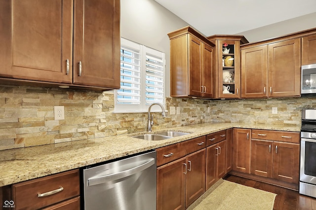 15410 Mission Hills Dr, Carmel, IN 46033 - kitchen featuring stainless steel appliances, light stone countertops, glass insert cabinets, tasteful backsplash, and dark wood-style floors