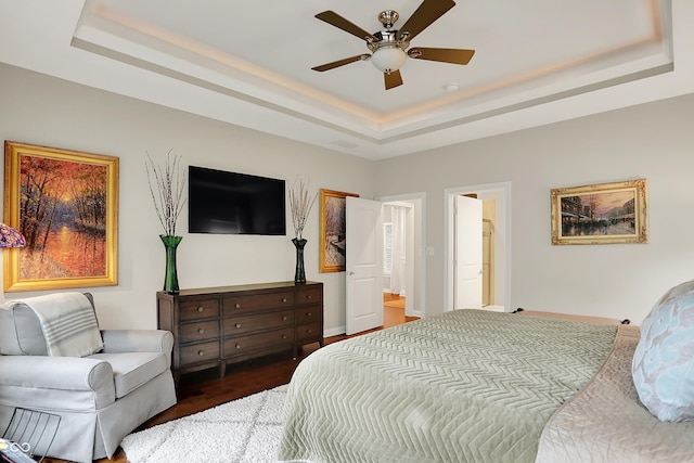 15410 Mission Hills Dr, Carmel, IN 46033 - bedroom with a tray ceiling, dark wood-style floors, and ceiling fan
