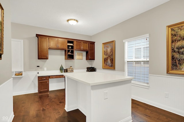 15410 Mission Hills Dr, Carmel, IN 46033 - kitchen featuring dark wood-style floors, light countertops, a kitchen island, a wainscoted wall, and brown cabinetry