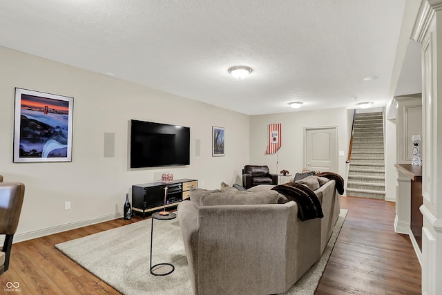 15410 Mission Hills Dr, Carmel, IN 46033 - living room featuring stairway, wood finished floors, and a textured ceiling