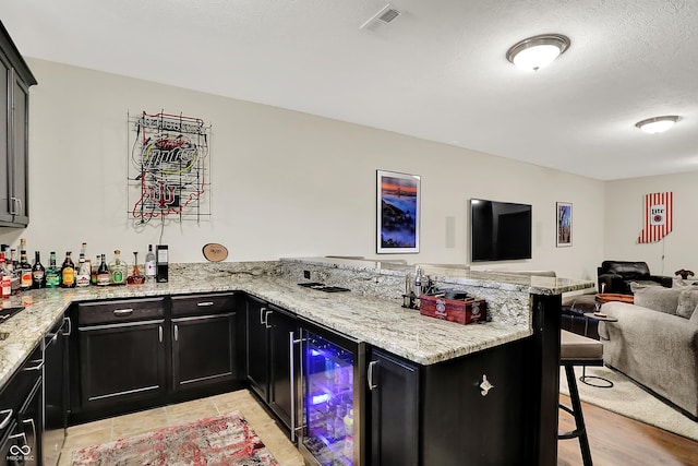 15410 Mission Hills Dr, Carmel, IN 46033 - indoor wet bar with beverage cooler and light wood finished floors