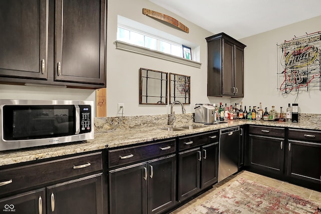 15410 Mission Hills Dr, Carmel, IN 46033 - kitchen featuring stainless steel appliances, light stone counters, and light tile patterned flooring