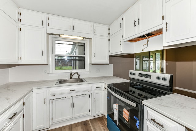 823 Rustic Rd, Anderson, IN 46013 - kitchen with stainless steel range with electric cooktop, white cabinets, and wood finished floors