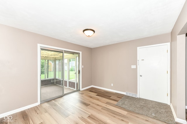 823 Rustic Rd, Anderson, IN 46013 - spare room with baseboards and light wood finished floors