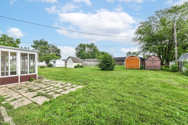 823 Rustic Rd, Anderson, IN 46013 - view of yard with a storage unit, a sunroom, and a patio