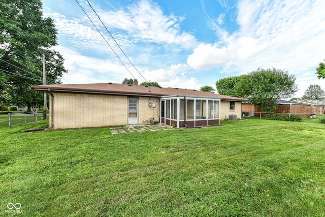 823 Rustic Rd, Anderson, IN 46013 - rear view of house featuring a sunroom and brick siding