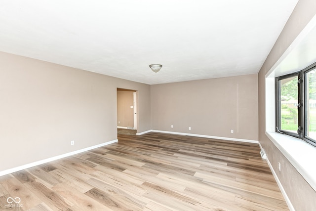 823 Rustic Rd, Anderson, IN 46013 - unfurnished room with baseboards and light wood-style flooring
